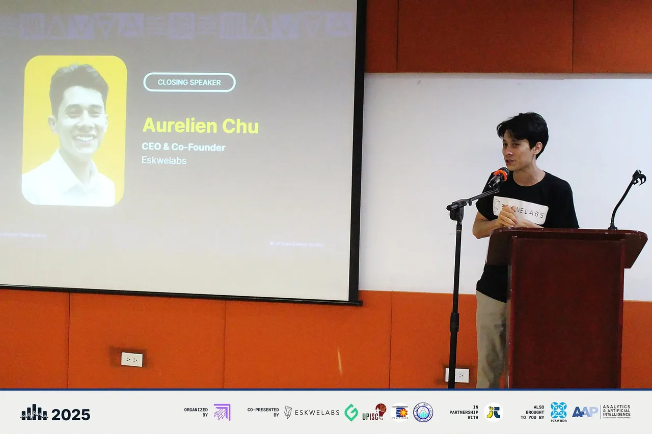 Aurelien Chu, CEO and co-founder of Eskwelabs, speaking at the lectern during the final round with his name on the screen behind him.